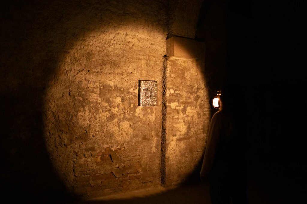 Visitor alone with candle – Contemplative experience